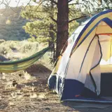 A tent and hammock at a camp site