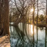 The clear blue water of Blue Hole Regional Park in Wimberley, Texas