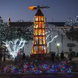 Fredericksburg's German Christmas pyramid lit at dusk in Marktplatz during the holiday season