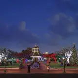 Families gathered around the lit Christmas tree and holiday displays at Marktplatz in Fredericksburg