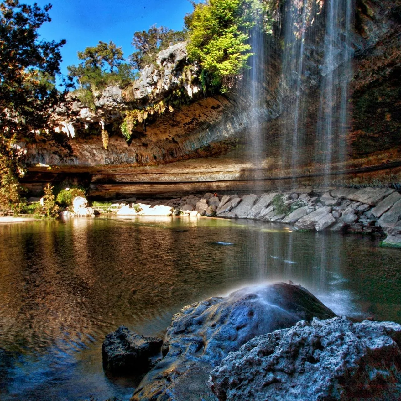 Hamilton Pool Preserve with limestone overhang and waterfall near Dripping Springs