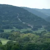 Scenic Texas Hill Country vista with rolling green hills and open sky