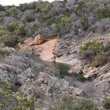 Scenic overlook view of Devil's Waterhole and the surrounding hills at Inks Lake State Park