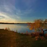 A warm sunset over Inks Lake's fall foliage