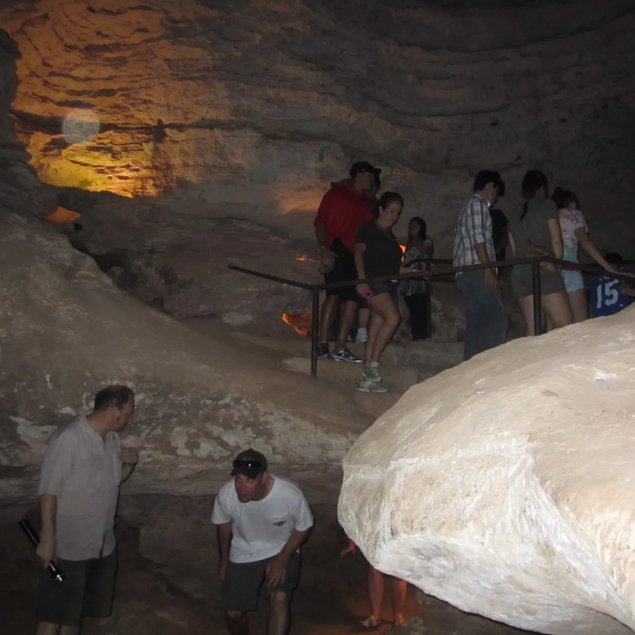 Visitors inside the limestone passages of Longhorn Cavern on a guided walking tour